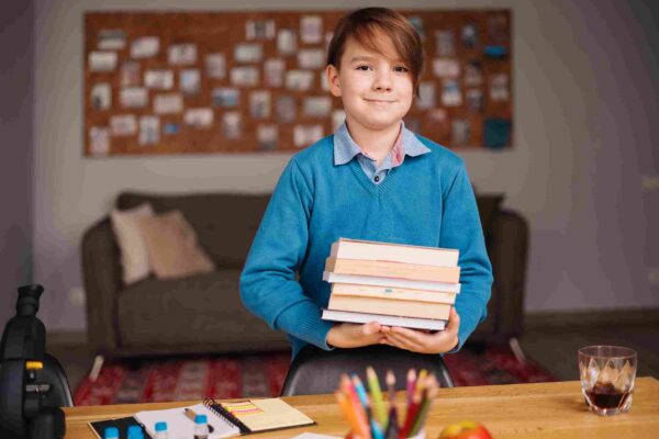 What revision materials do you recommend for CEM/GL 11 Plus exams? 11 Plus student holding revision materials for 11 Plus Exams